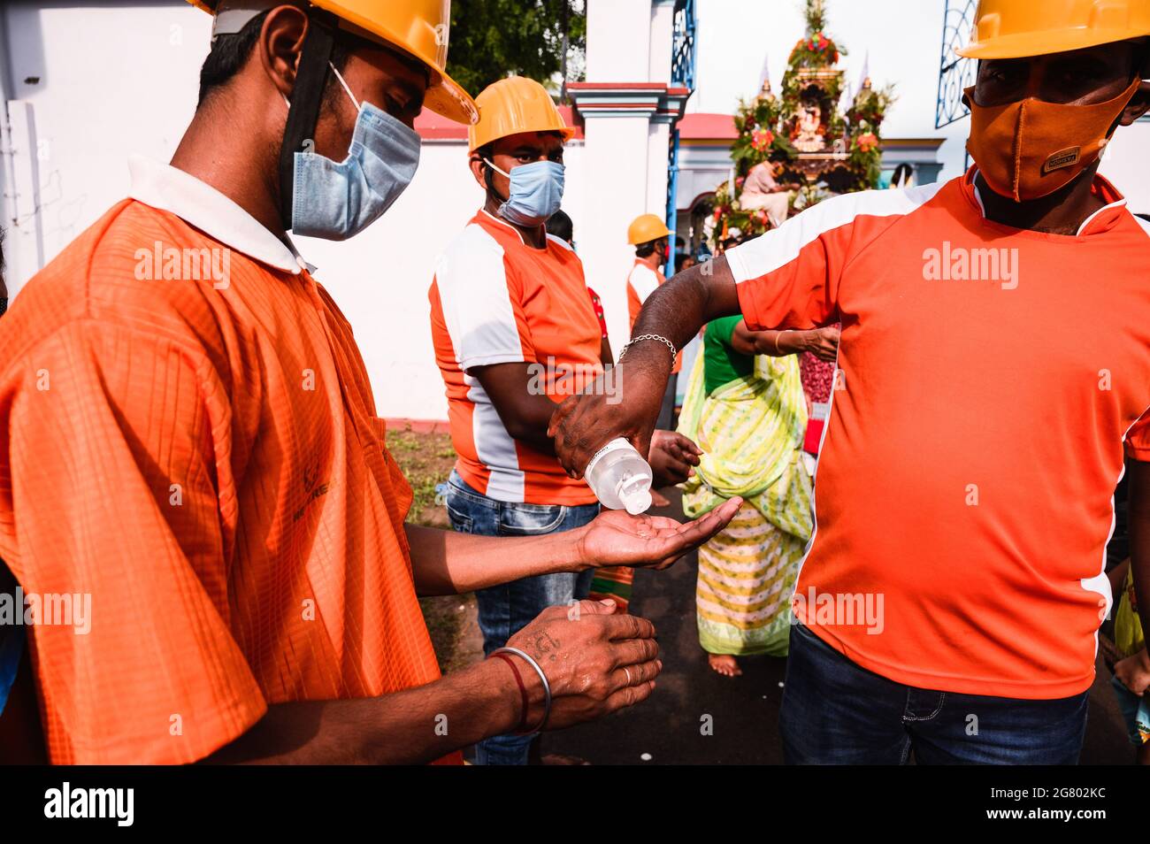 Das Ratha Yatra-Fest wurde im Tempel in Tehatta gemäß den Verwaltungsregeln für Vorsichtsmaßnahmen gegen das Coronavirus gefeiert. Sie durften nicht ohne Masken eintreten. Eine freiwillige Organisation half mit Desinfektionsmittel für die Anhänger. Obwohl es Regeln gab, trugen einige Kinder und Ältere keine Masken oder trugen die Masken nicht richtig. Tehatta, Westbengalen; Indien. Stockfoto