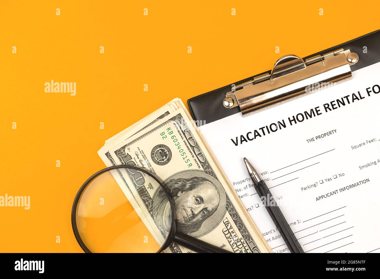 Formular für die Vermietung von Ferienimmobilen. Hypothekenkredit-Konzept, Zwischenablage mit Zustimmung, Geld und Stift. Draufsicht Stockfoto