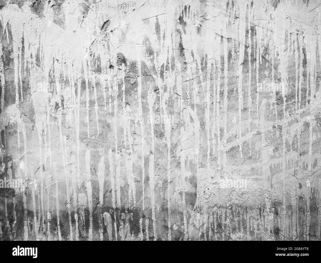 Die Betonwand hat weiße Farbflecken, die nach unten fließen. Leere alte schmutzige Grunge Zement Wand Textur Hintergrund. Stockfoto