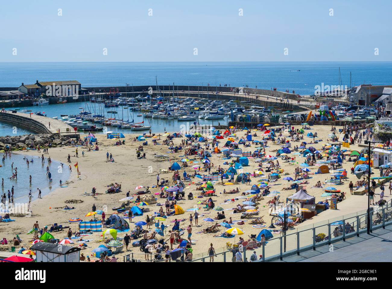 Lyme Regis, Dorset, Großbritannien. Juli 2021. UK Wetter: Massen von Strandbesuchern strömen an den vollen Strand im Badeort Lyme Regis, um sich in sengenden heißen Sonnenschein zu sonnen, während die Temperaturen am sogenannten 'Freedom Day' ansteigen. Die Hitzewelle wird sich in dieser Woche fortsetzen. Kredit: Celia McMahon/Alamy Live Nachrichten Stockfoto