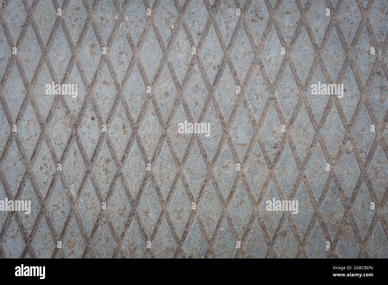 Abstrakter industrieller Hintergrund. Betonoberfläche mit Gittermuster. Die Rückseite ist grau. Steinmauer. Stockfoto