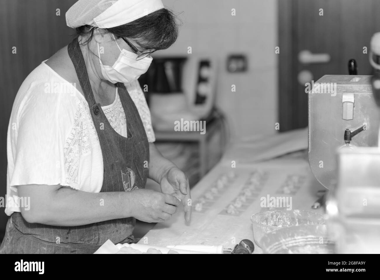 PIACENZA, ITALIEN - 17. Jul 2021: Frau, die Tortelli , traditionelle gefüllte italienische Pasta, zubereitet Stockfoto