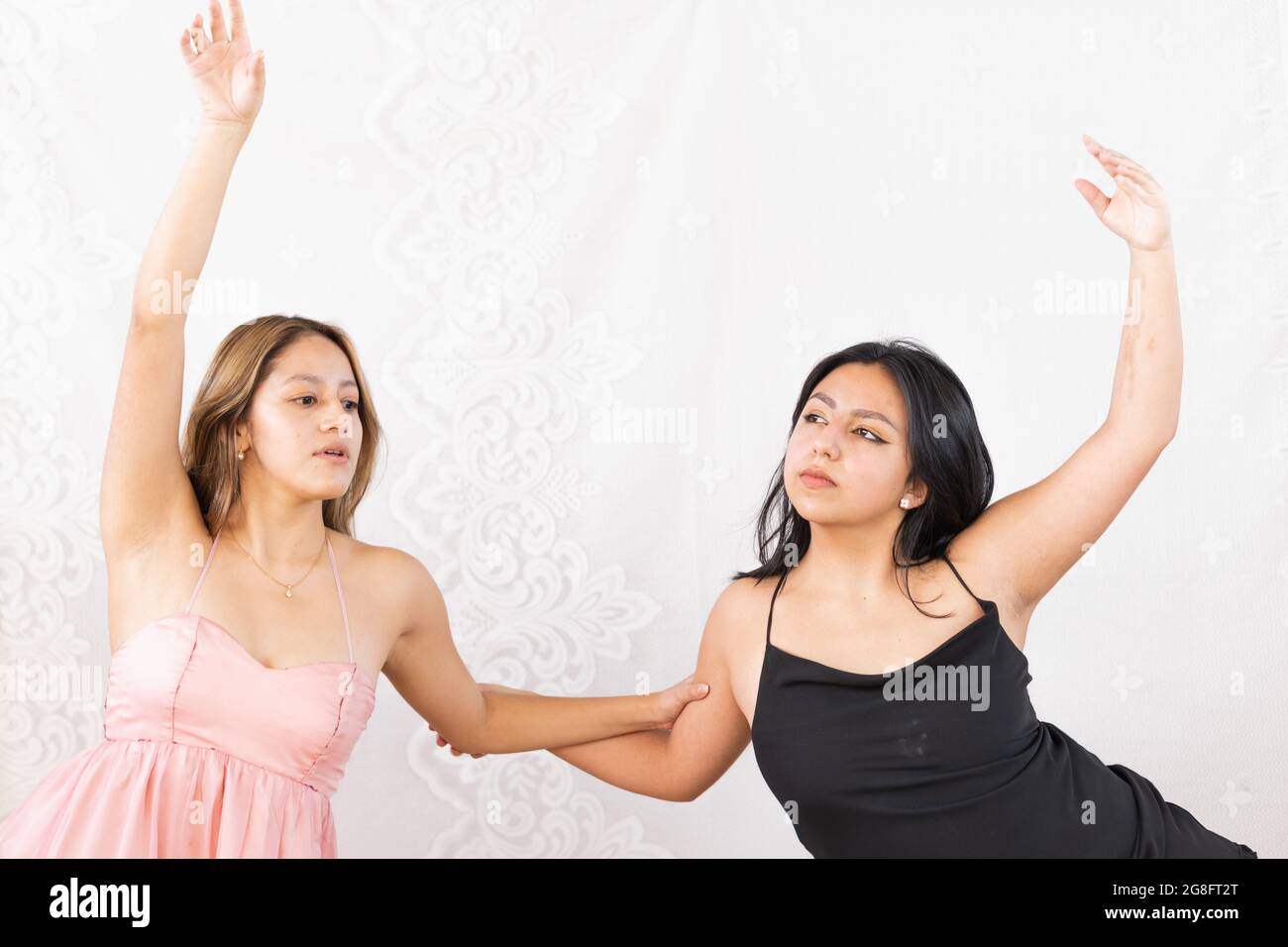 Junge Frauen üben Tanzschritte, um ihr Talent auf weißem Hintergrund zu entwickeln Stockfoto