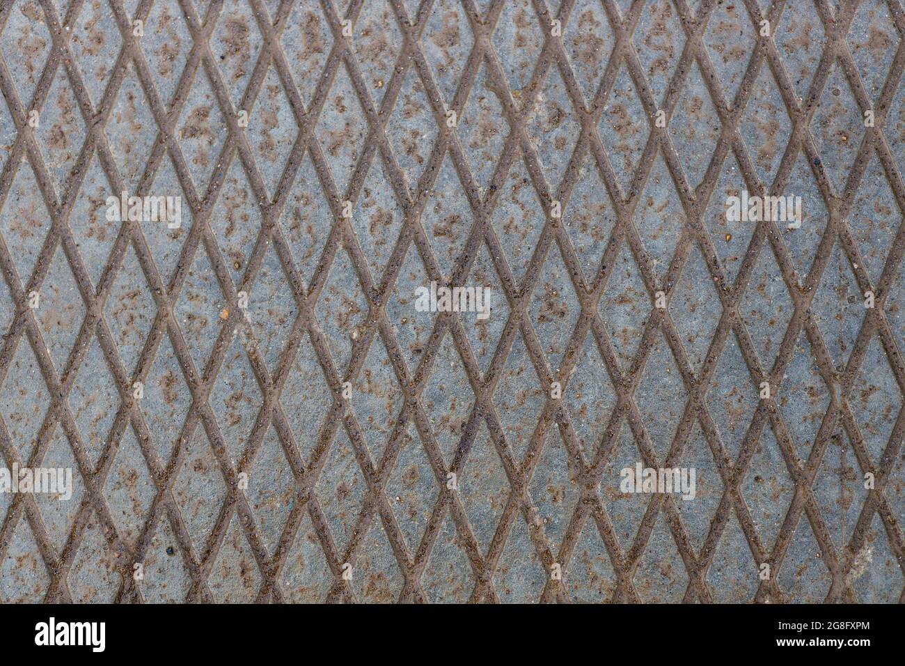 Abstrakter industrieller Hintergrund. Betonoberfläche mit Gittermuster. Die Rückseite ist grau. Steinmauer. Stockfoto