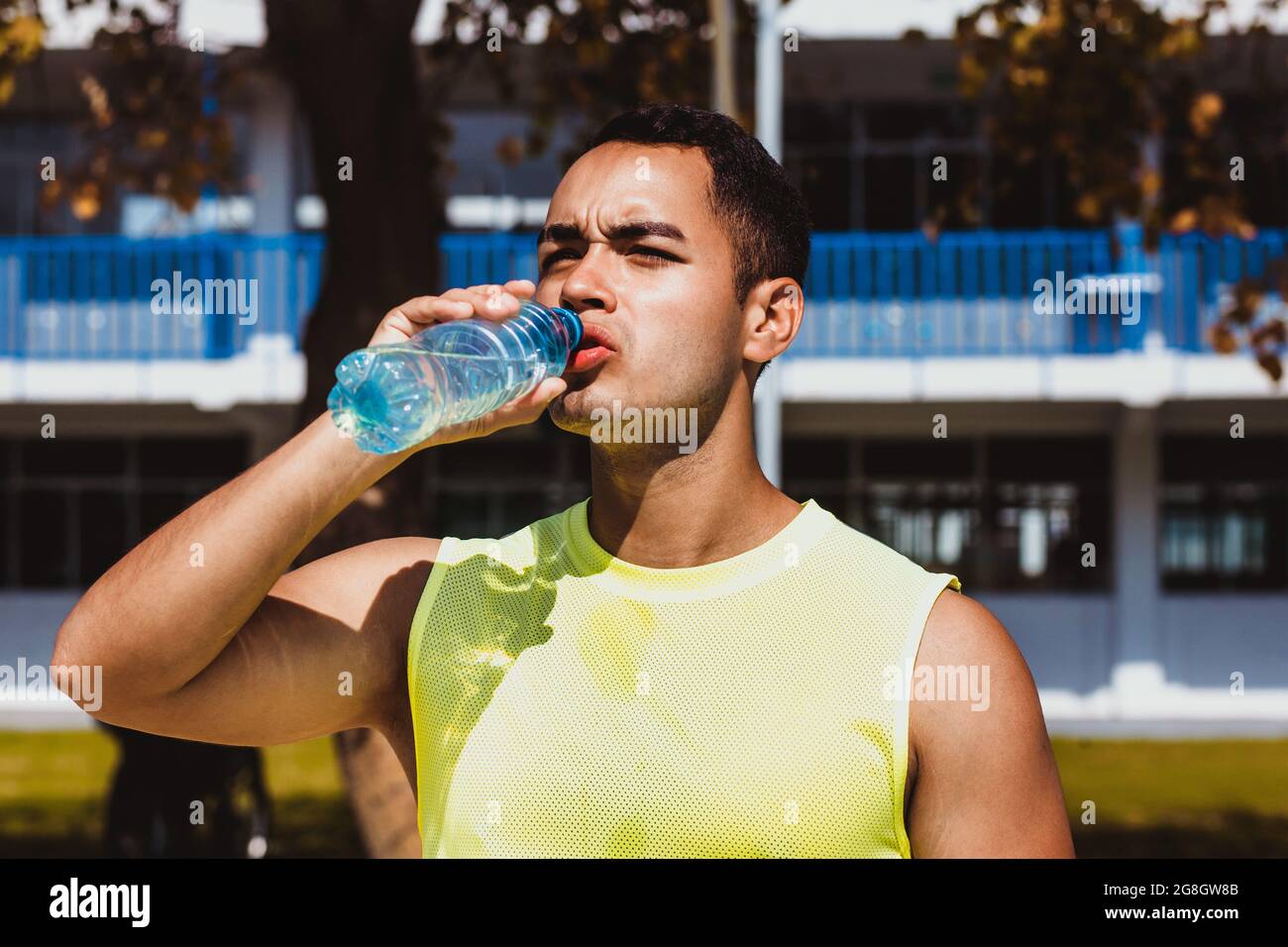 Porträt eines jungen lateinamerikaners, der nach seiner Ausbildung in Mexiko, Lateinamerika, eine Flasche Wasser trinkt Stockfoto