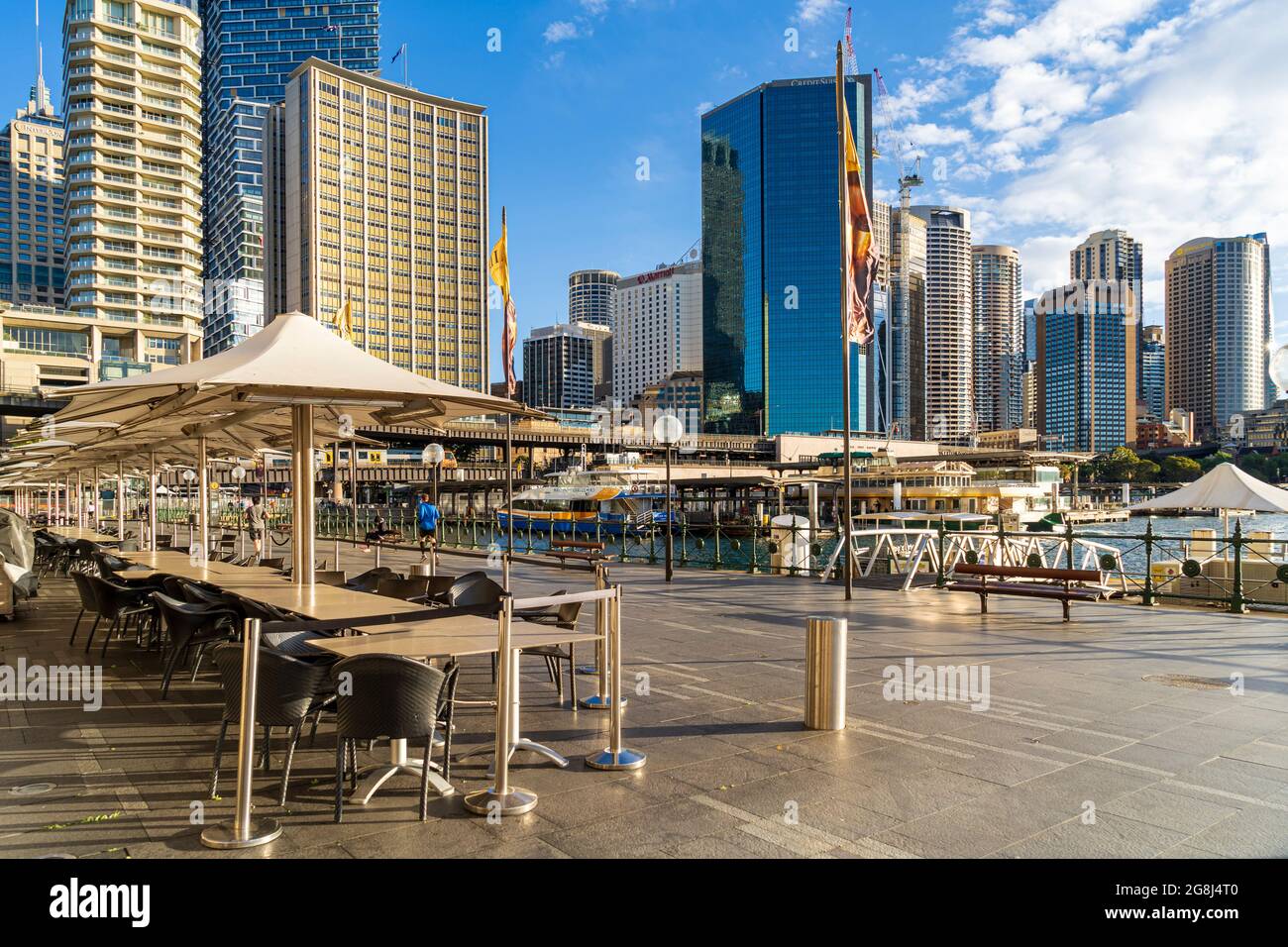 Leere Tische in Außenrestaurants am Circular Quay, Sydney, Australien während der Sperre. Blauer Himmel und Skyline der Stadt Stockfoto