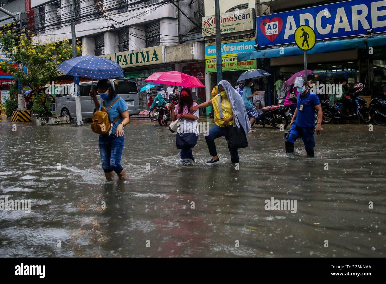 Manila, Philippinen. Juli 2021. Menschen waten durch die Flut, die durch schwere Monsunregen in Manila, Philippinen, 21. Juli 2021, heraufbeschossen wurde. Quelle: Rouelle Umali/Xinhua/Alamy Live News Stockfoto