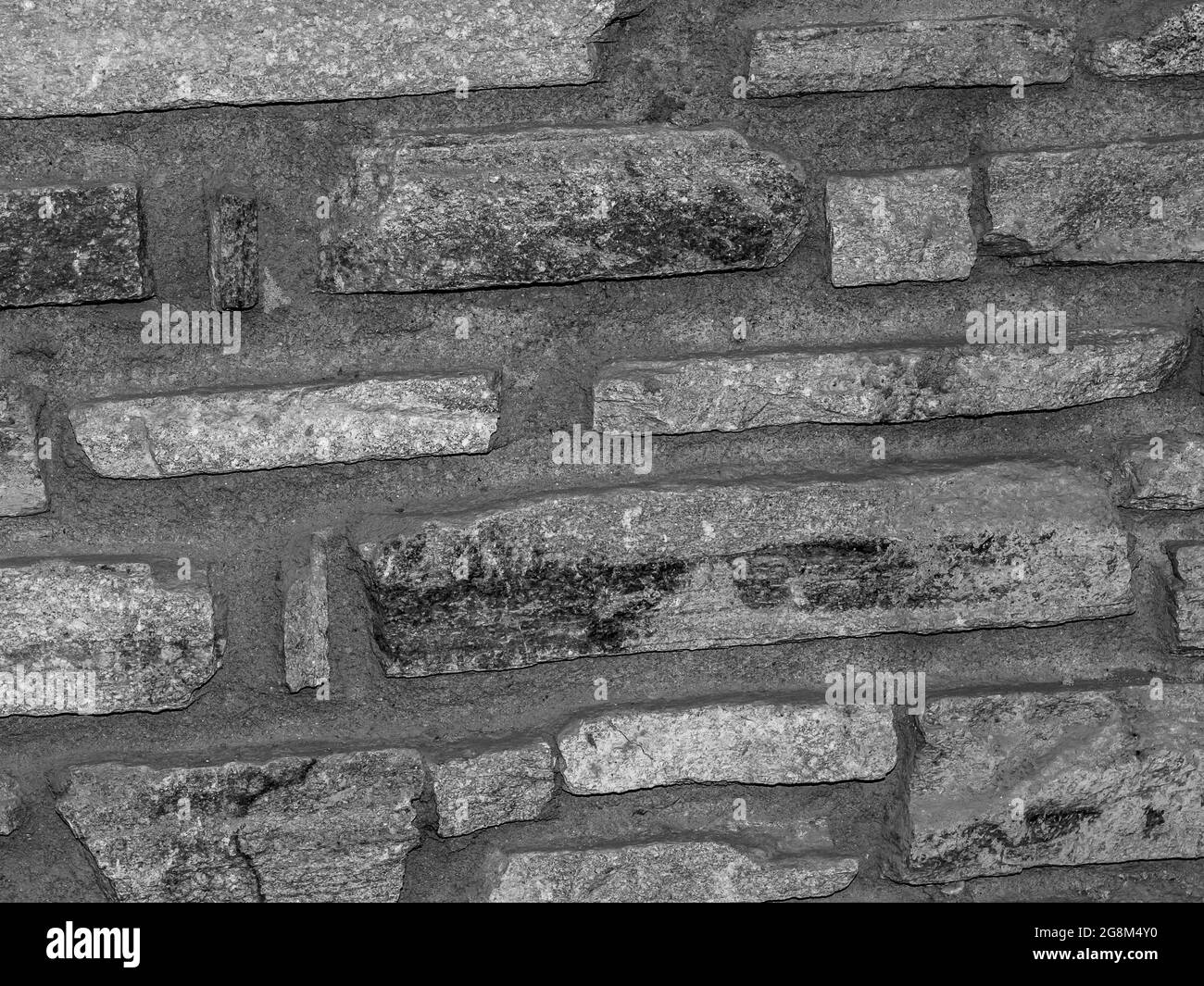 Tapete aus rustikalem Steinwall Stockfoto