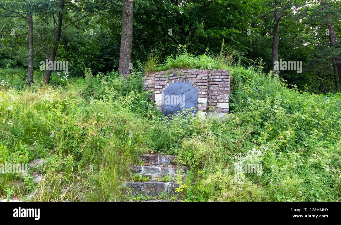 Der Keller ist in den Bergen gemacht. Eingang zum Weinkeller mit geschlossenen Türen und Steintreppen. Stockfoto