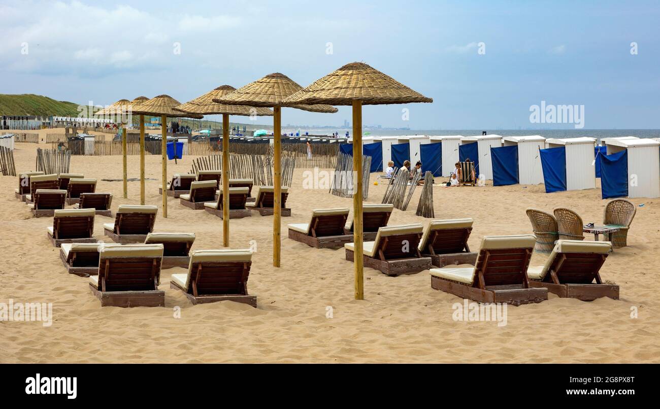 Sommersaison mit Liegestühlen und Sonnenschirmen am Strand entlang der Nordseeküste in Katwijk, Südholland, Niederlande. Stockfoto