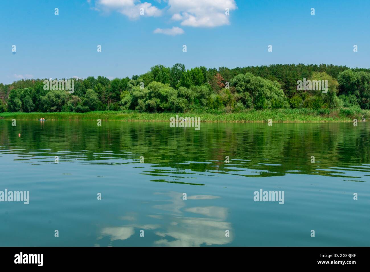 Großer Fluss Oskol im Osten der Ukraine. Schöne Landschaft des Flusses vor dem Hintergrund des Waldes und des blauen Himmels. Weiße Wolken sind es Stockfoto