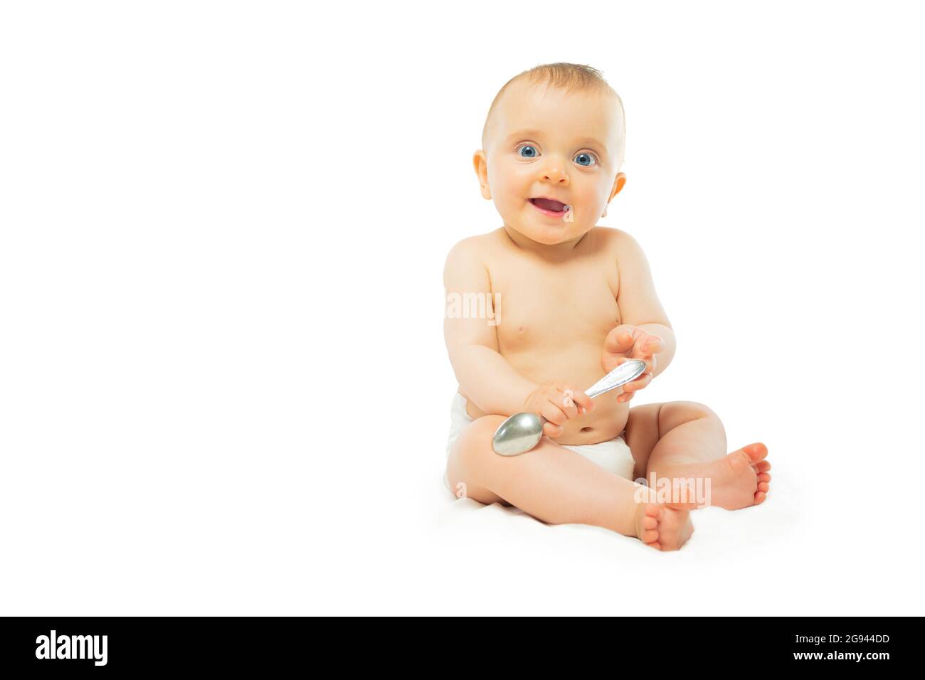 Baby in Windel isoliert auf weiß sitzen mit Löffel Stockfoto