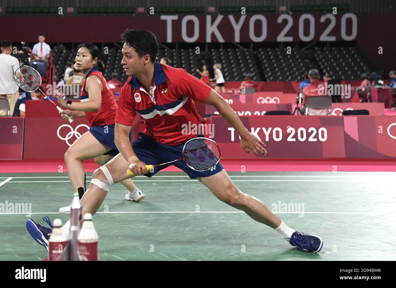 Tokio, Japan. Juli 2021. Der Kanadier Joshua Hurlburt-Yu und Teamkollege Jospehine Wu im Einsatz gegen Thailand beim Doppel-Badminton-Wettbewerb bei den Olympischen Spielen 2020 in Tokio, Samstag, 24. Juli 2021, Japan. Leere Sitze im Hintergrund zeugen davon, dass bei den Sommerspielen aufgrund der Covid-Pandemie keine Zuschauer zugelassen sind. Foto von Mike Theiler/UPI Credit: UPI/Alamy Live News Stockfoto