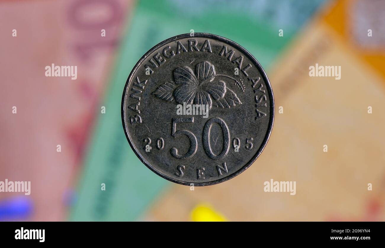 Geld, 50-sen-Münzen auf verschwommenem Hintergrund der Banknote von Ringgit Malaysia, ausgewählter Fokus. Handel & Unternehmen, Finanzen, Wirtschaft und Investment Concept. Stockfoto