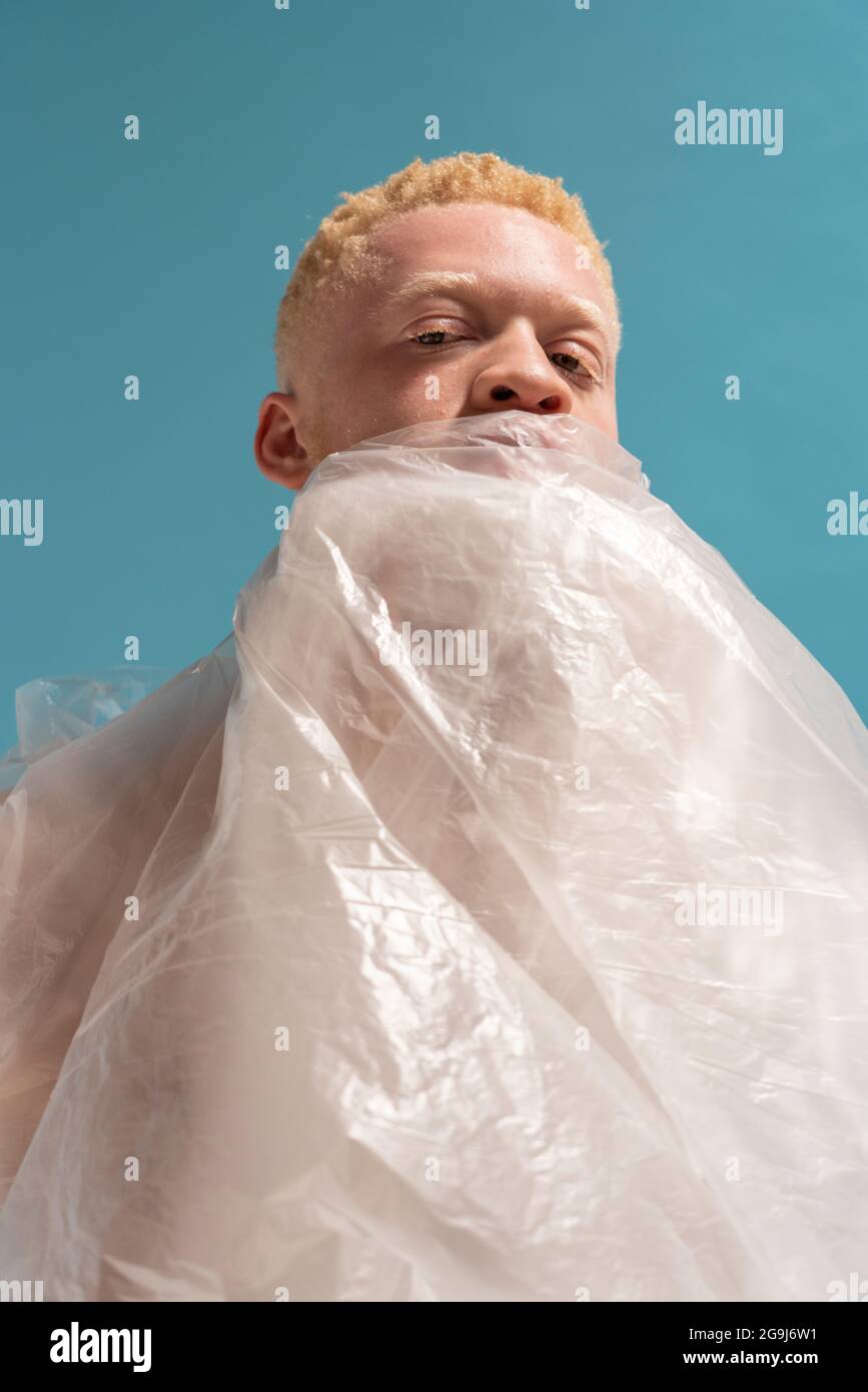 Studio Porträt von Albino Mann in Plastikfolie eingewickelt Stockfoto
