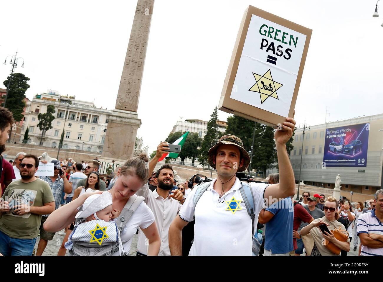 Rom, Italien. Juli 2021. Ein Mann mit seiner Frau und seinem Kind, zeigt ein Banner, das symbolisiert, dass der Grüne Pass wie der David-Stern ist, der auf die Kleidung der juden in nazi-Faschismus-Zeiten genäht wurde, während der Demonstration gegen den Grünen Pass, Das bescheinigt die Impfung gegen covid 19, nach dem letzten Dekret des ministerrats, notwendig, um öffentliche Plätze wie Büros, Schulen, aber auch Restaurants zu betreten.Rom (Italien), 27. Juli 2021 Foto Samantha Zucchi Insidefoto Kredit: Insidefoto srl/Alamy Live News Stockfoto