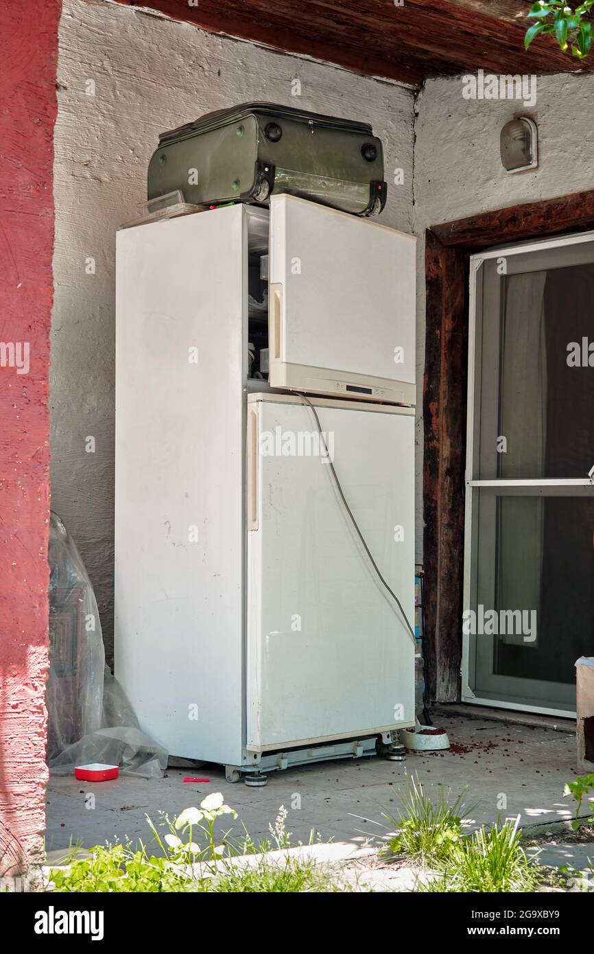 Veralteter alter Kühlschrank oder Kühlschrank, der am Eingang eines Hauses  weggeworfen wird Stockfotografie - Alamy
