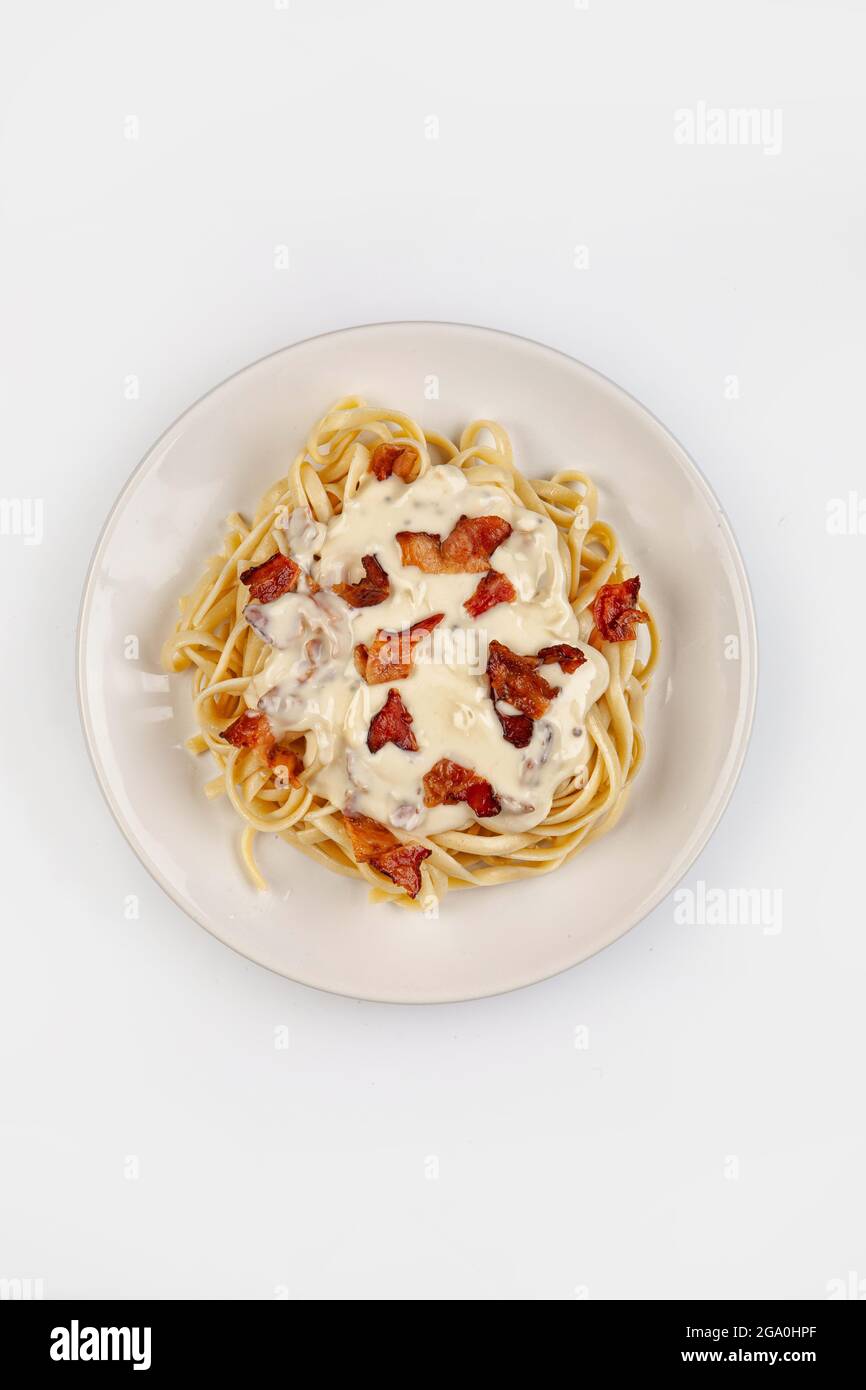 Spaghetti und Sauce auf einem Teller auf isoliertem Studiohintergrund Stockfoto