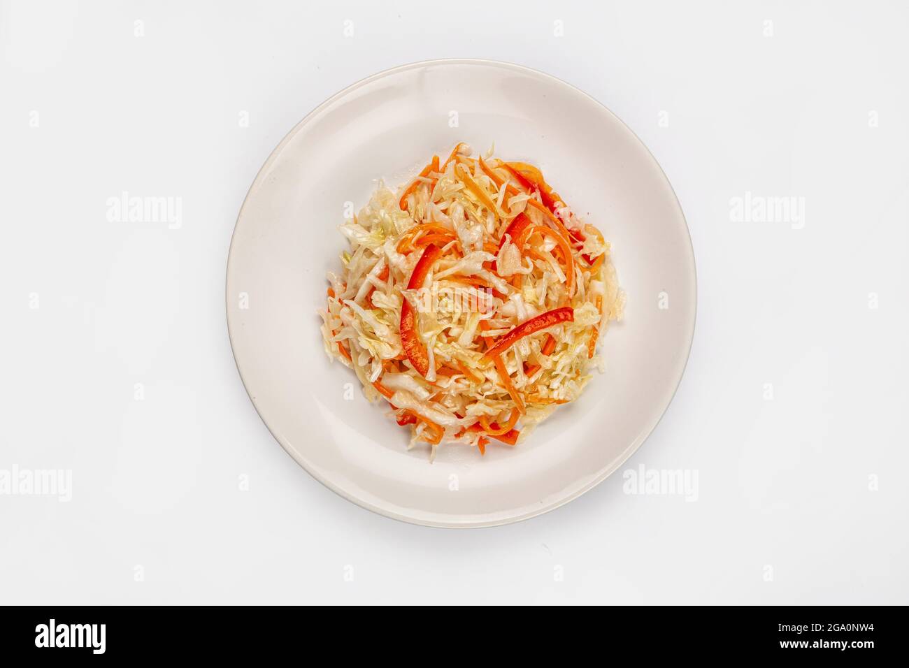 Kohlsalat mit Karotte auf einem Teller auf isoliertem Studiohintergrund Stockfoto