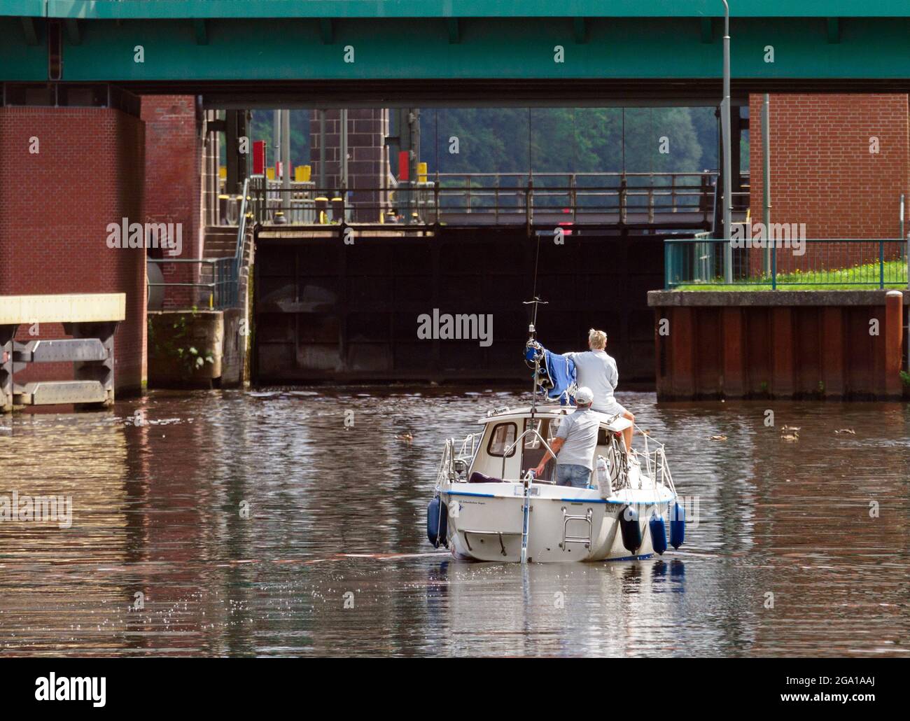 Kleinmachnow, Deutschland. Juli 2021. Ein Motorboot wartet im Teltow-Kanal vor der Kleinmachnower-Schleuse. Der Teltow-Kanal verläuft über rund 38 Kilometer durch Brandenburg und Berlin und ist eine wichtige Berliner Südumfahrung für die Handelsschifffahrt und ein beliebtes Ziel für Camper, Bootstouristen und auch Wanderer. In Dreilinden zum Beispiel gibt es in der Nähe des Kanalufers bis zum Machnower See mehr oder weniger schmale Fußwege. Quelle: Soeren Stache/dpa-Zentralbild/ZB/dpa/Alamy Live News Stockfoto