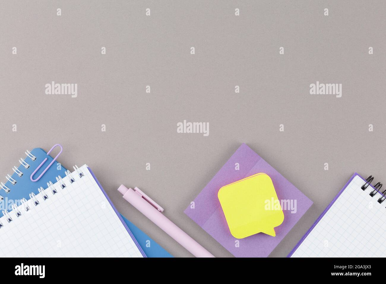 Grauer Schulschreibtisch mit Bildungsmaterial. Stockfoto