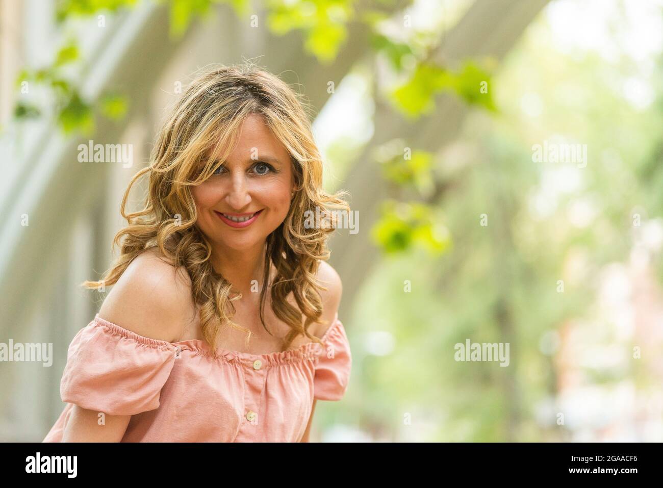 Porträt einer glücklichen reifen Frau mit Bäumen Hintergrund Stockfoto