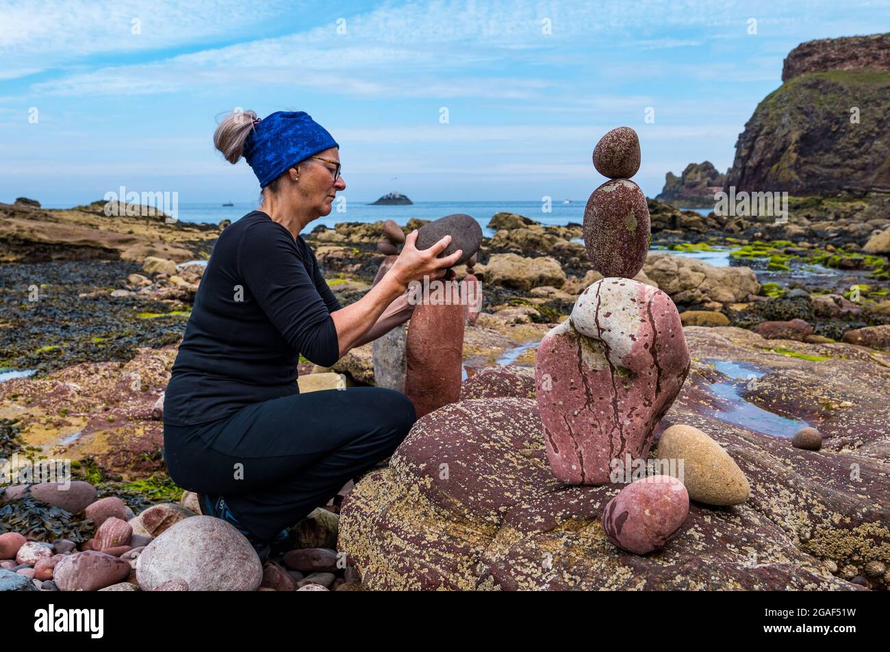 Caroline Walker, Steinstapler, balanciert Steine bei der European Stone Stacking Championship am Strand, Dunbar, East Lothian, Schottland, Großbritannien Stockfoto