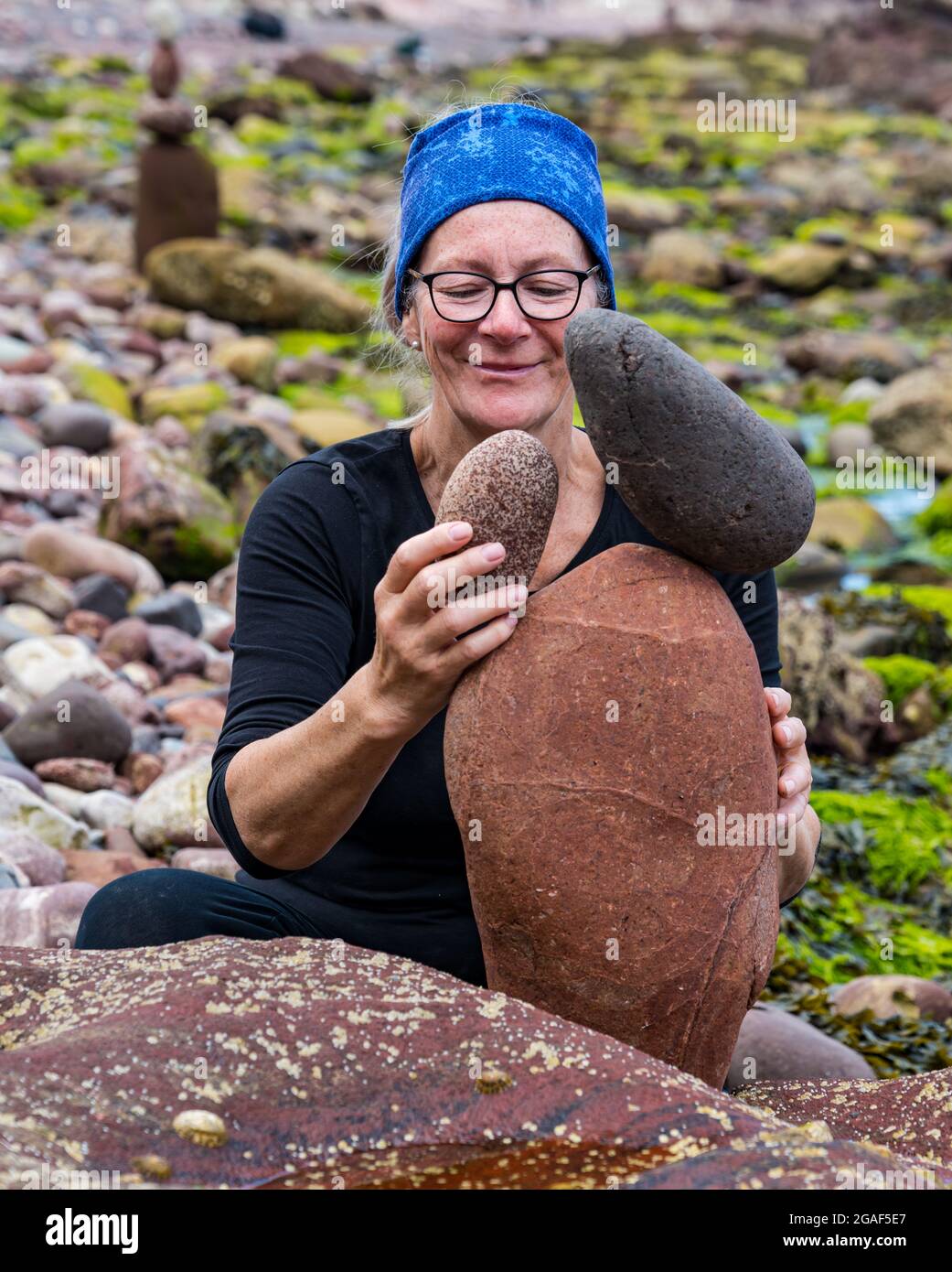 Caroline Walker, Steinstapler, balanciert Steine bei der European Stone Stacking Championship am Strand, Dunbar, East Lothian, Schottland, Großbritannien Stockfoto