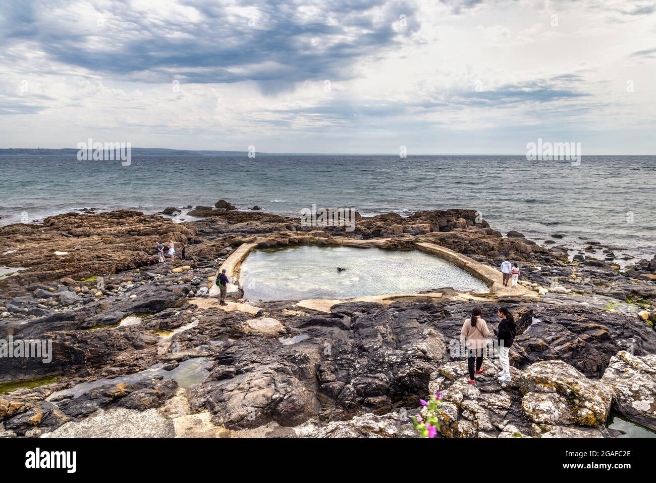 Felsenpool in Mousehole mit Blick auf das Meer entlang des South West Coast Path, Penwith Penwith Peninsula, Cornwall, Großbritannien Stockfoto