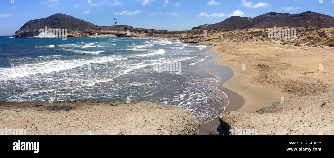 Ein Kitesurfer genießt sein Hobby am einsamen Strand 'Playa de los Genoveses' in Almeria, Andalusien, Spanien. Wassersport-Konzept Stockfoto