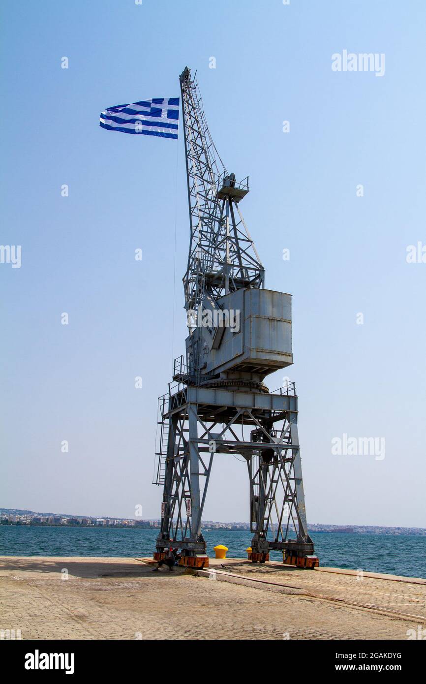 Thessaloniki, Griechenland, 15. Juli 2021. Griechische Flagge auf einem Kran im Hafen von Thessaloniki Stockfoto