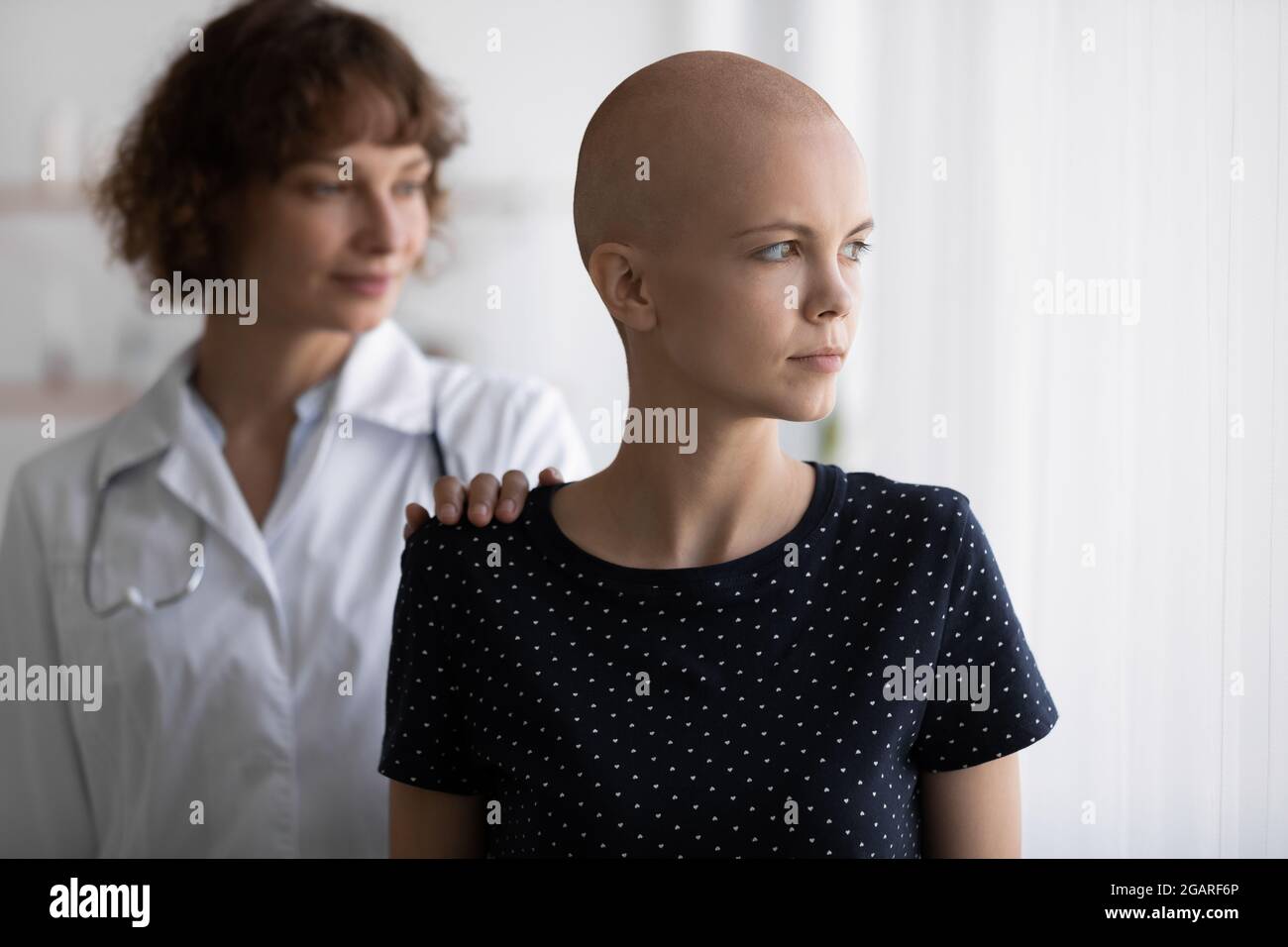 Junge Onkologin unterstützt gestresste Krebspatientin. Stockfoto