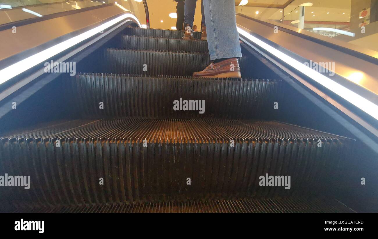Rolltreppe mit Menschen, die darauf stehen Stockfoto