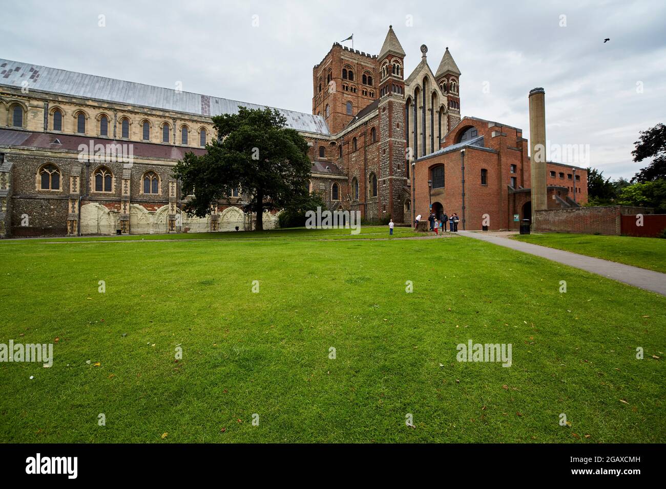 St Albans Cathedral und der streng aussehende Cathedral Gift Shop, dessen letzterer im Jahr 1981 erbaut wurde. Stockfoto