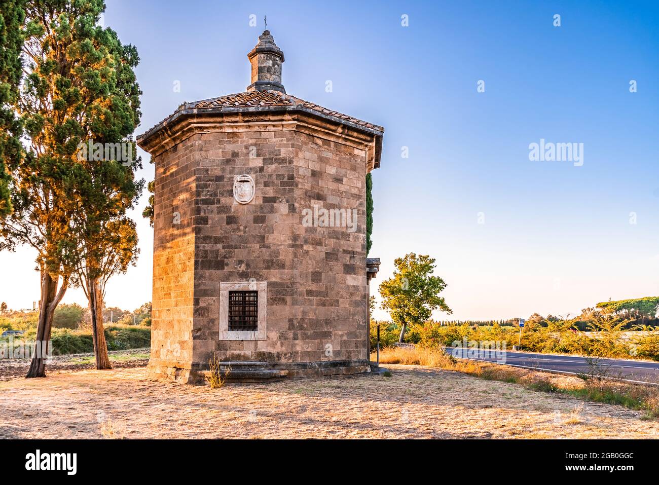 Oratorium von San Guido bei Sonnenuntergang. Es wurde von der Familie Gherardesca vor der 'Viale dei Cipressi' (Zypressenallee) in Bolgheri, Toskana, erbaut Stockfoto