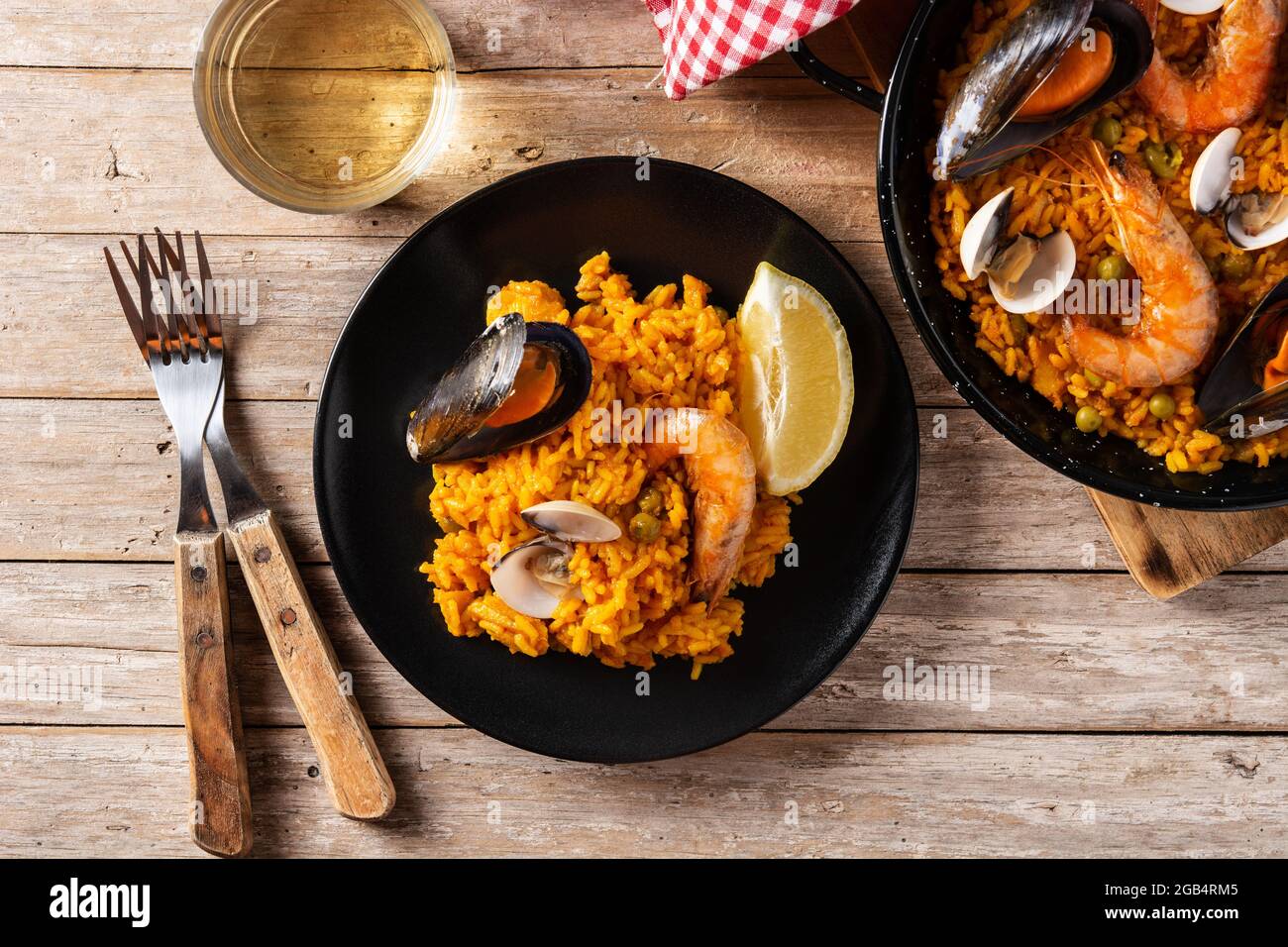 Traditionelle spanische Paella mit Meeresfrüchten auf einem Holztisch Stockfoto