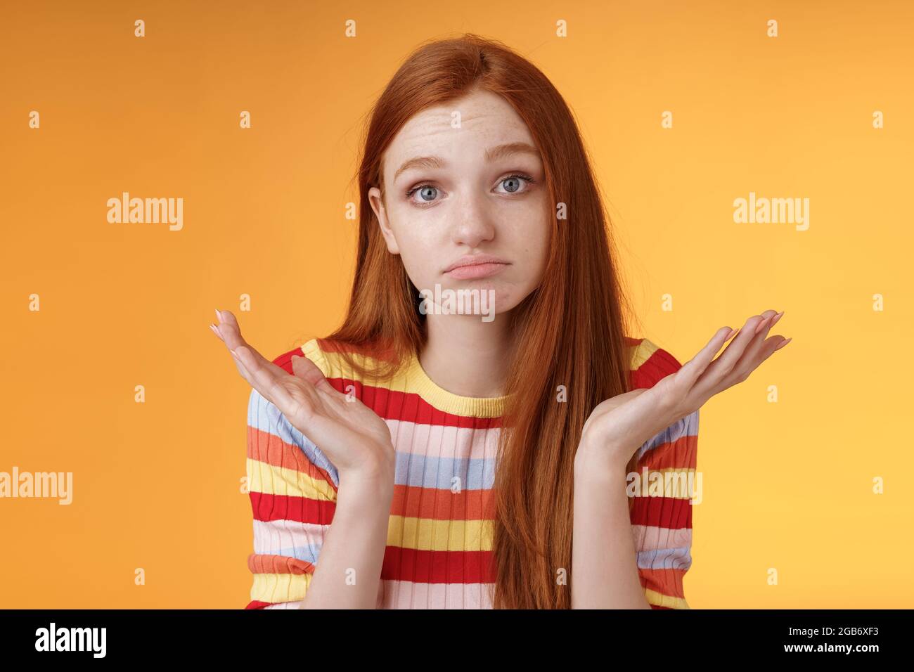 Ahnungslos aufgeregt Rotschopf junge nette weibliche Mitarbeiter zuckende Hände zu verbreiten Sideays ahnungslos Pouting verwirrt kann Frage nicht zu entschuldigen beantworten nicht Stockfoto