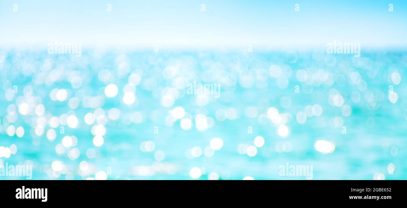 Defokussierte Meerwasseroberfläche glitzert auf der Sonne. Stockfoto
