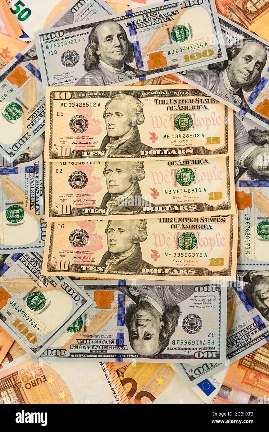 Viele Dollar und Euro, Textur des Geldes, der Vorteil des Euro gegenüber dem Dollar. Neu Stockfoto