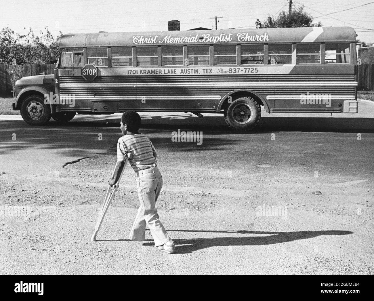 Austin, Texas, USA, um 1984: Der Junge der 4. Klasse Patrick Skeaton, der eine Spina bifida hat und in der 3. Klasse ein Bein amputiert haben musste. Die Fotogeschichte zeigt ihn an einem typischen Schultag; hier benutzt er seine Krücken, um zur Kirche seiner Familie zu gehen. ©Bob Daemmrich Stockfoto