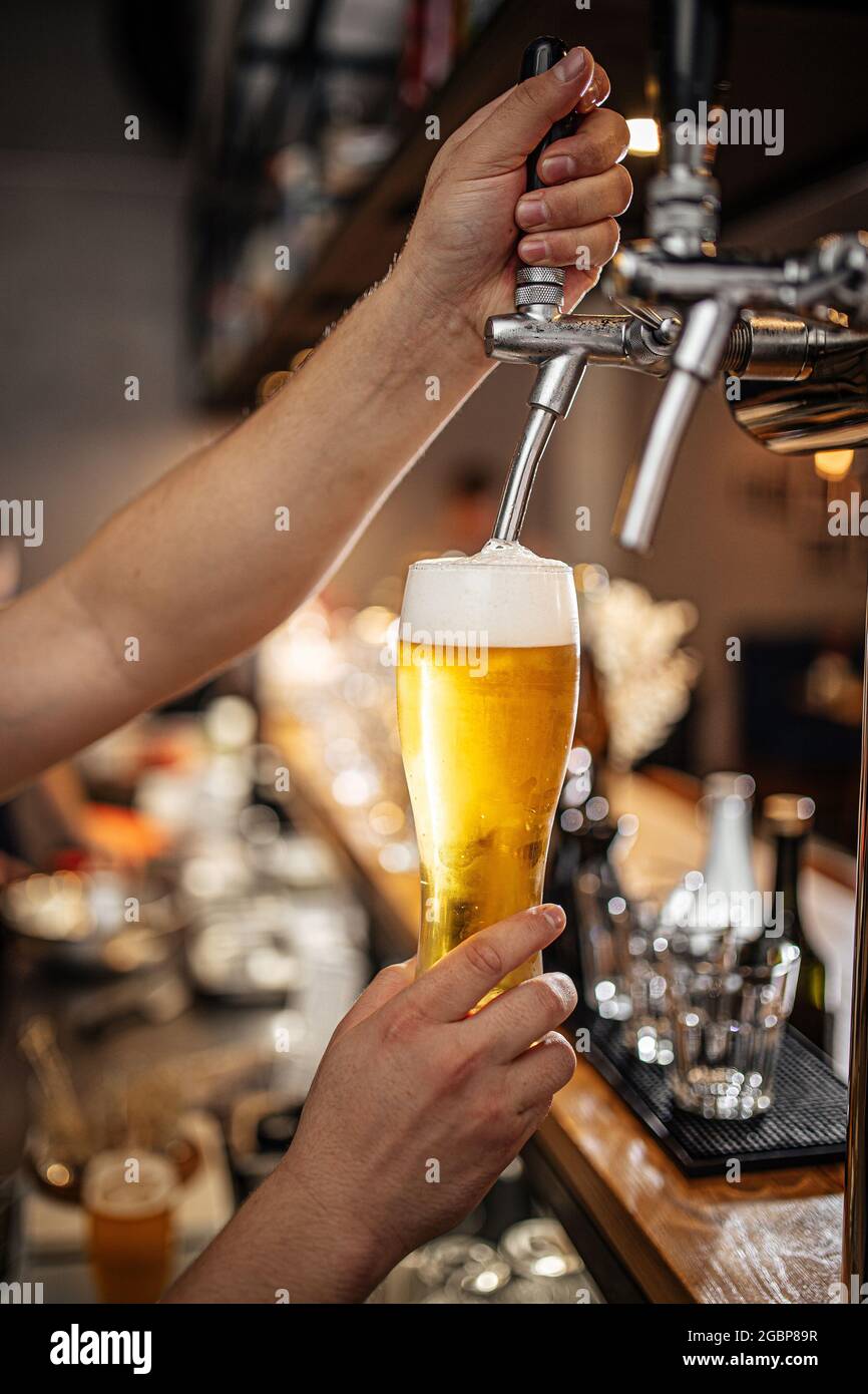 Hände, die Bier vom Fass in ein Glas gießen Stockfotografie - Alamy