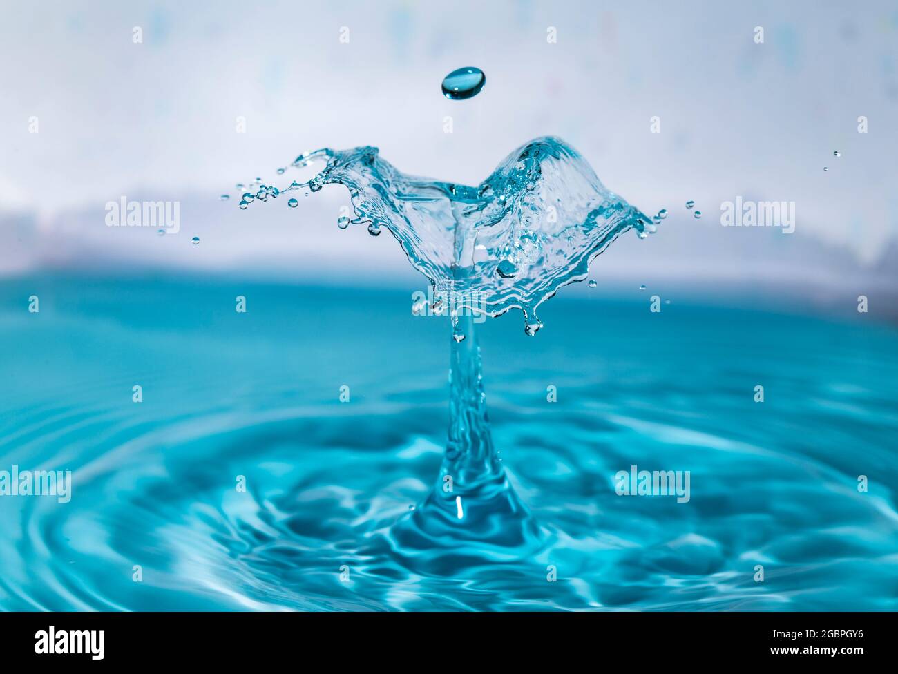 Zusammenstoß mit blauem Wassertropfen Stockfoto