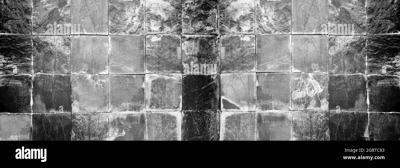 Alte Steinwand Hintergrund mit dunkler Farbe für Design in Ihrem Arbeitshintergrund. Stockfoto