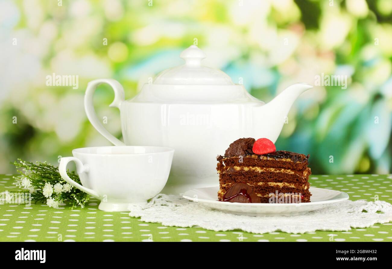 Teekanne, Tasse Tee und leckeren Kuchen auf natürlichem Hintergrund  Stockfotografie - Alamy