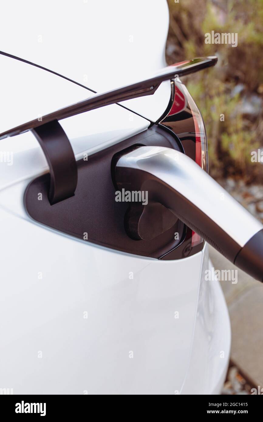 Stock Foto eines Steckers Laden eines modernen Elektroautos oder Elektroautos im Kraftwerk. Nachhaltige Mobilität und umweltfreundliches Konzept für alternative Energien Stockfoto Stock Foto eines Steckers Laden eines modernen Elektroautos oder Elektroautos im Kraftwerk. Nachhaltige Mobilität und umweltfreundliches Konzept für alternative Energien Stockfoto