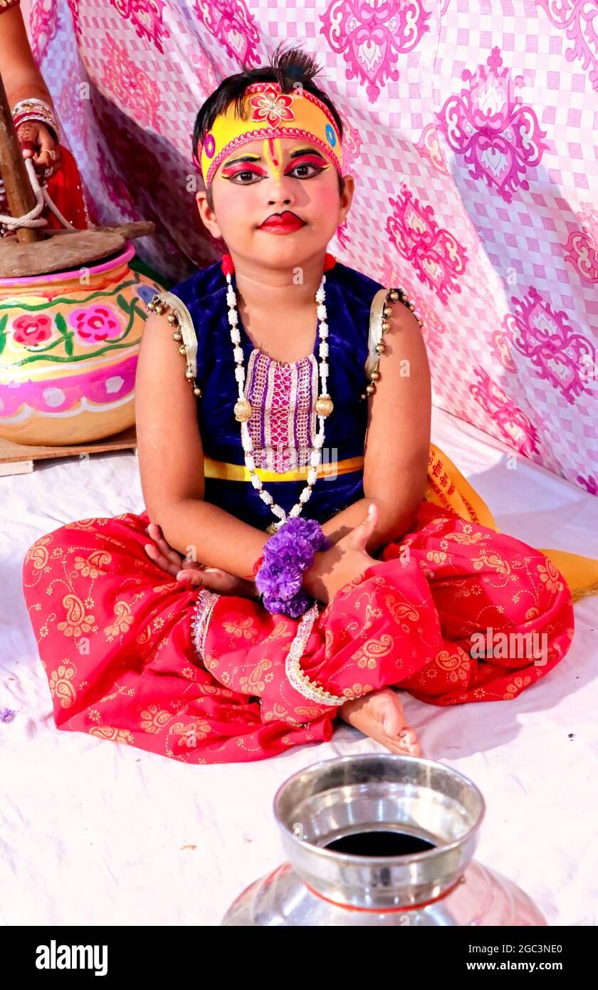 Hansi, haryana, August 2020 : EIN Kind rollt Lord Krishna mit einem Topf Butter - Janmashtami-Konzept Stockfoto