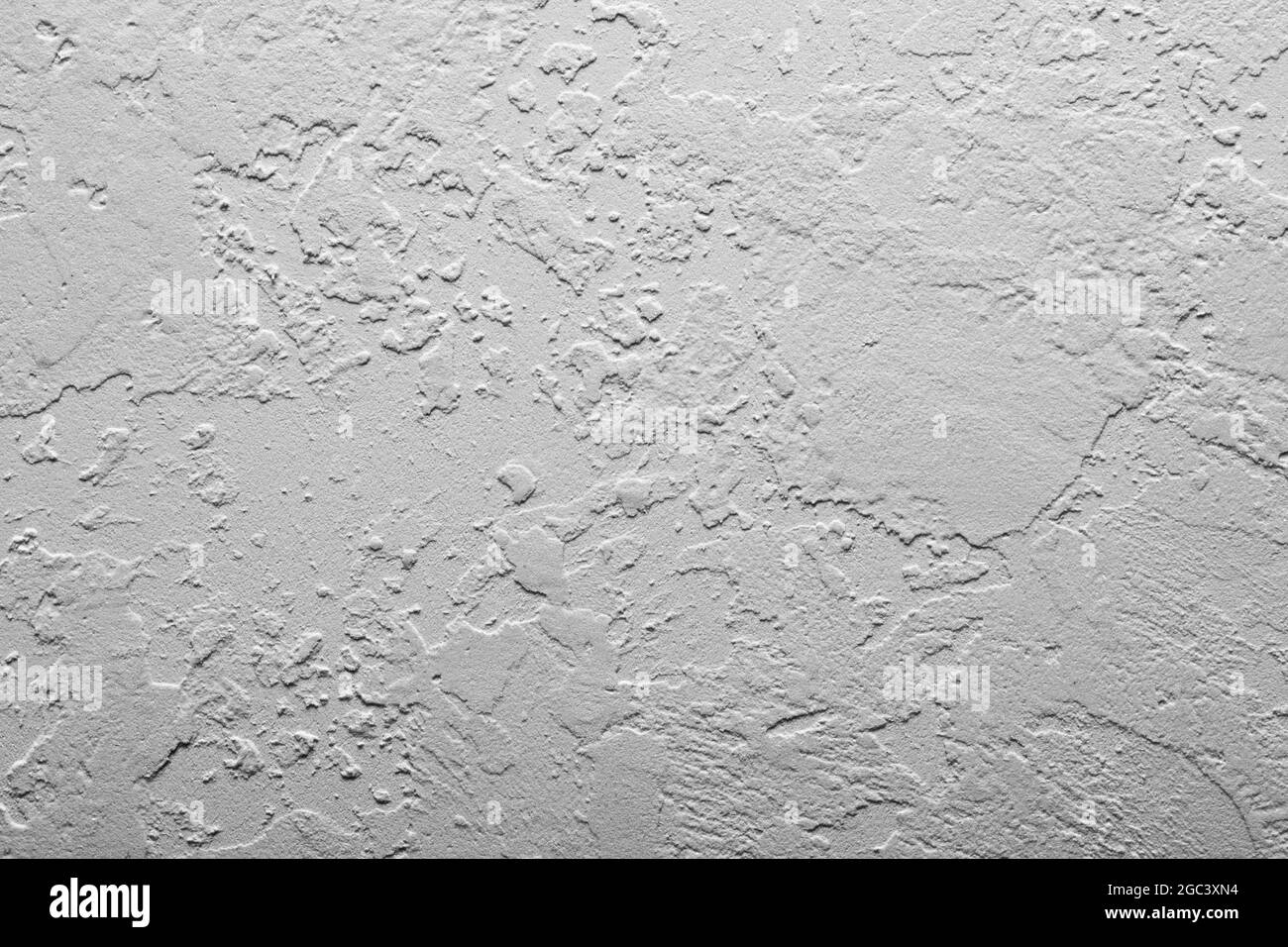 Heller Wandstuck, Beton mit abstrakten Punkten. Schöne graue, weiße Textur oder Hintergrund, abstrakte Wandoberfläche Hintergrund, ungewöhnliche fleckige Oberfläche. Stockfoto