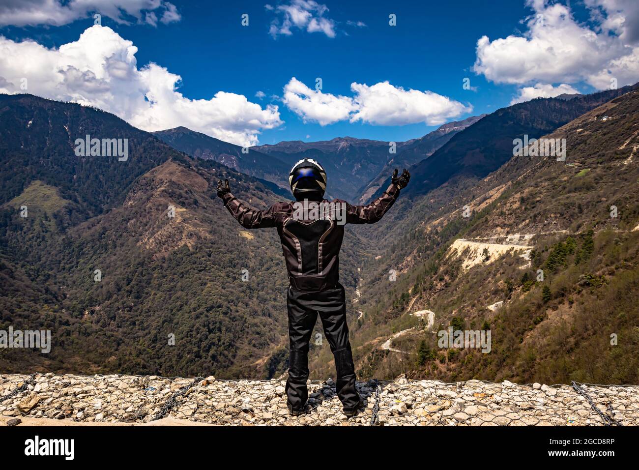 Biker, die Sicherheitsvorrichtungen an der Bergspitze mit hellblauem Himmel am Tag tragen, werden am sela-Pass tawang arunachal pradesh india aufgenommen. Stockfoto