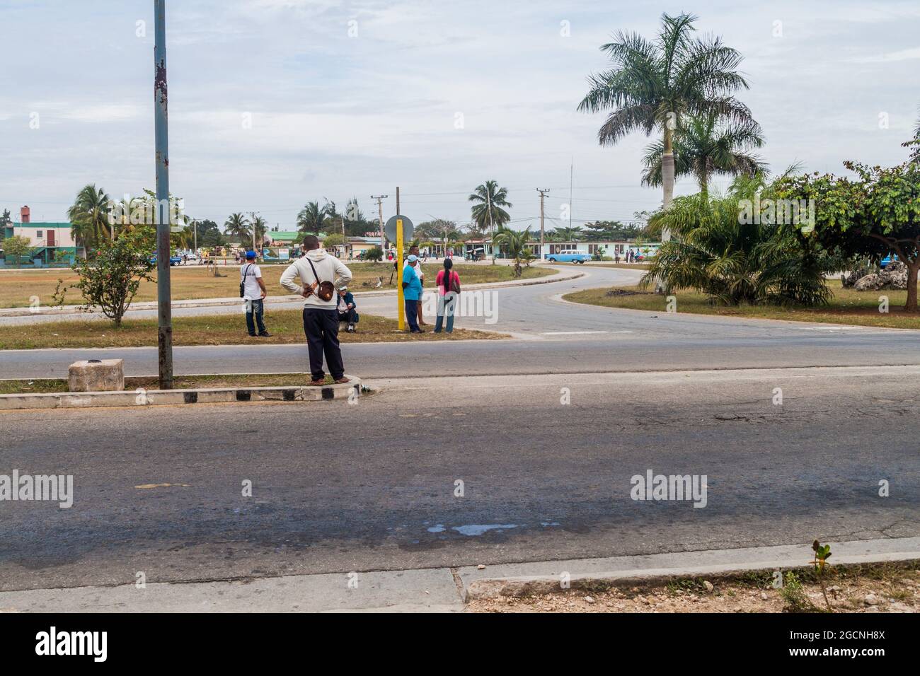 PLAYA LARGA, KUBA - 16. FEB 2016: Anhalter warten an einem Straßenrand im Dorf Playa Larga, Kuba. Stockfoto