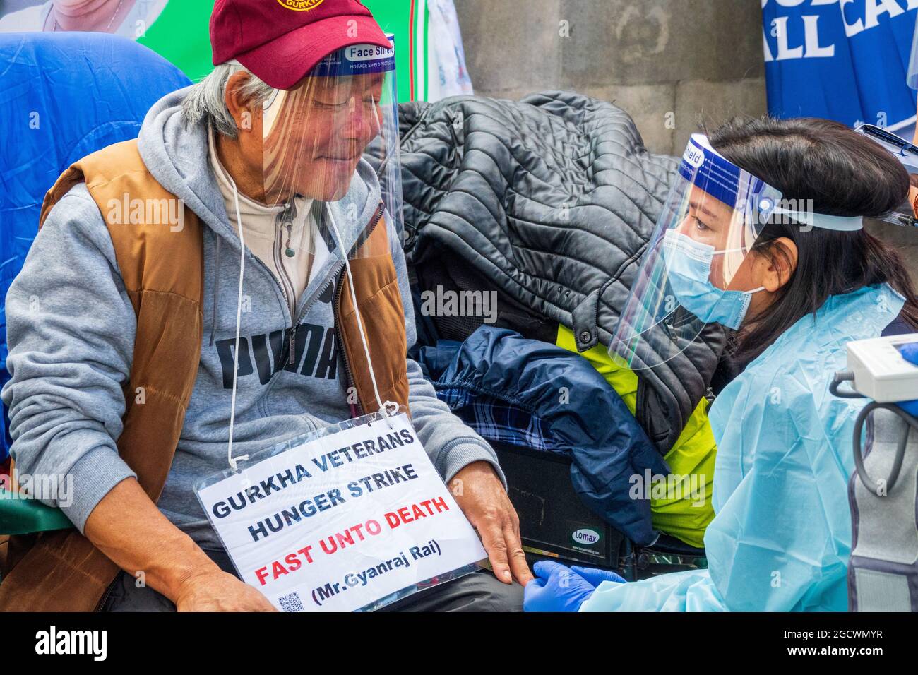 London, Großbritannien. 10th. August 2021. Krankenschwestern betreuen Herrn Gyanraj Rai, um während des Hungerstreiks sein medizinisches Wohlergehen zu gewährleisten. Britische Gurkha-Veteranen im Hungerstreik vor der Downing Street 10 fordern gleiche Rentenansprüche und Anerkennung von Boris Johnson in ihrem Dienst für Großbritannien. Stockfoto